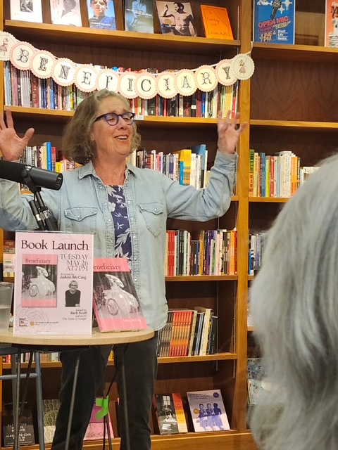 JoAnn McCaig reading at book launch for 2026 book, Beneficiary